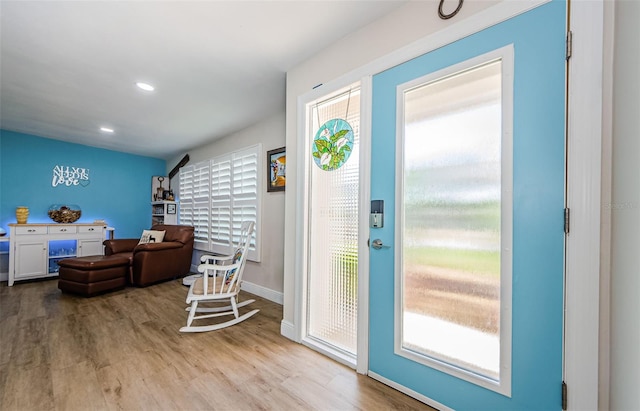 foyer entrance with wood finished floors, recessed lighting, and baseboards
