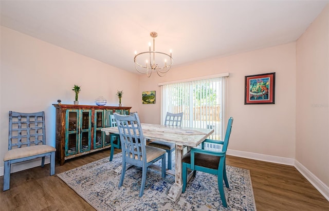 dining area with an inviting chandelier, wood finished floors, and baseboards
