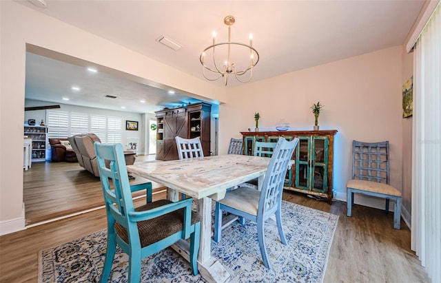 dining room with recessed lighting, an inviting chandelier, light wood-style floors, visible vents, and baseboards