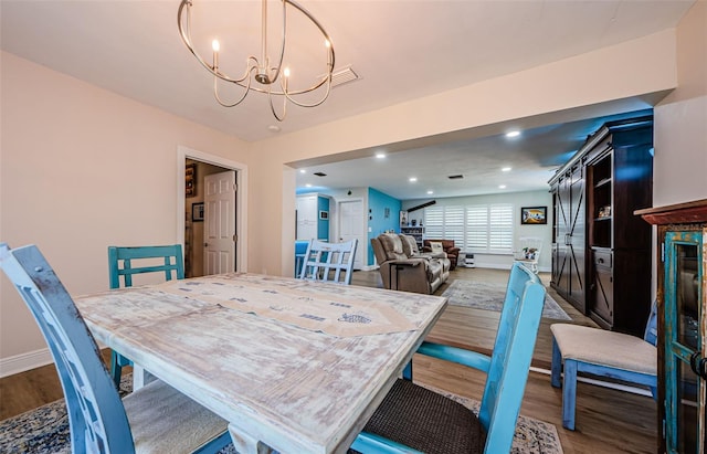 dining room with recessed lighting, wood finished floors, baseboards, visible vents, and a notable chandelier