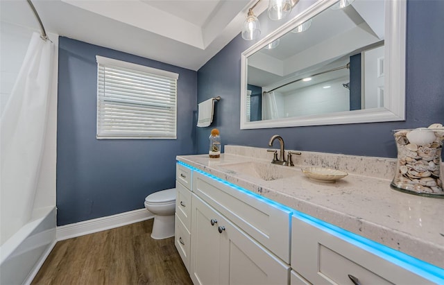bathroom featuring wood finished floors, toilet, vanity, and baseboards