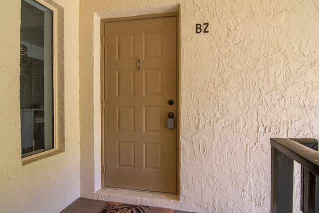 1400 Pine Glen Ln Unit B2, Tarpon Springs, FL 34688 - doorway to property featuring stucco siding