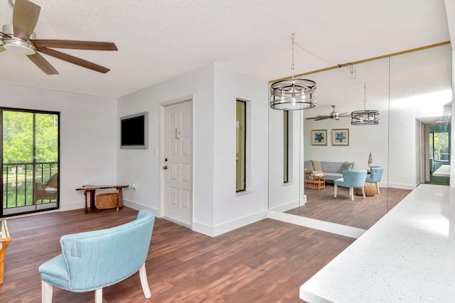 1400 Pine Glen Ln Unit B2, Tarpon Springs, FL 34688 - interior space featuring baseboards, a healthy amount of sunlight, wood finished floors, and ceiling fan with notable chandelier