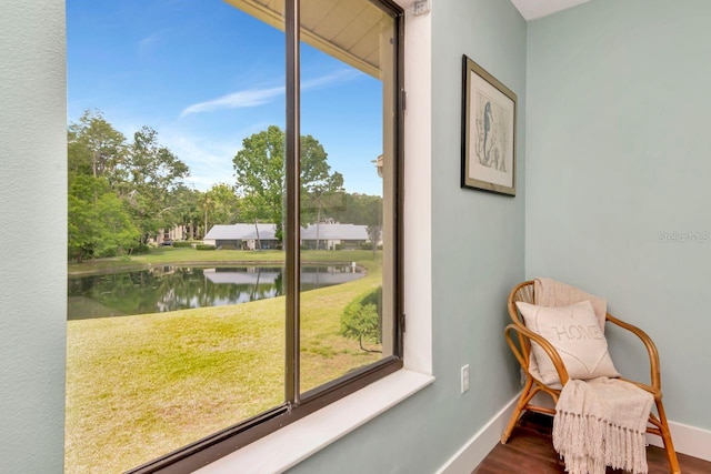 1400 Pine Glen Ln Unit B2, Tarpon Springs, FL 34688 - living area featuring wood finished floors, a water view, and baseboards