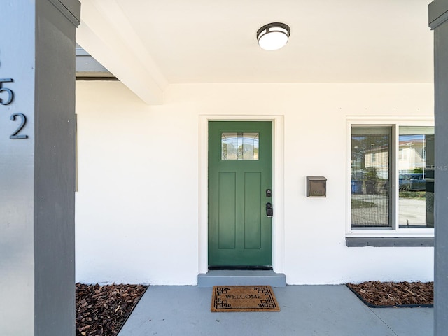 doorway to property with stucco siding