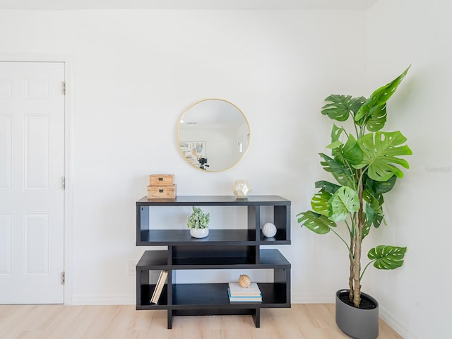 interior details featuring wood finished floors and baseboards