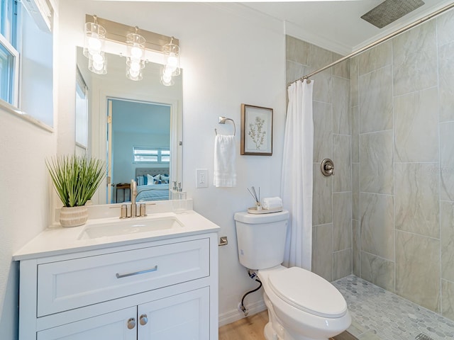 bathroom featuring toilet, vanity, ensuite bathroom, and tiled shower