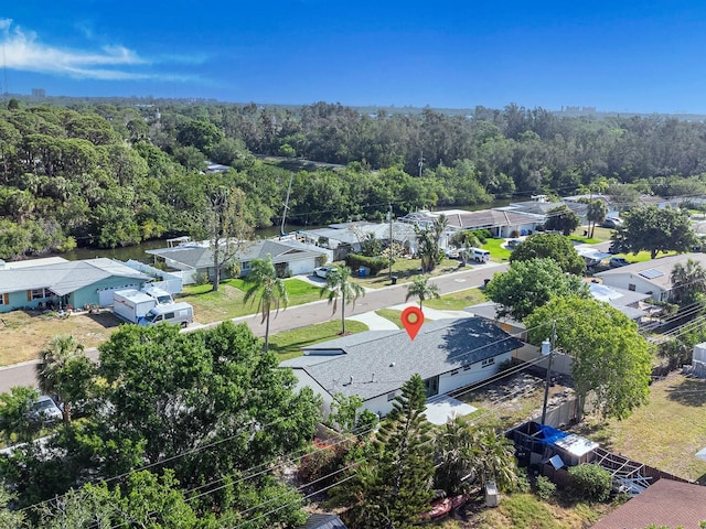 birds eye view of property with a residential view and a wooded view