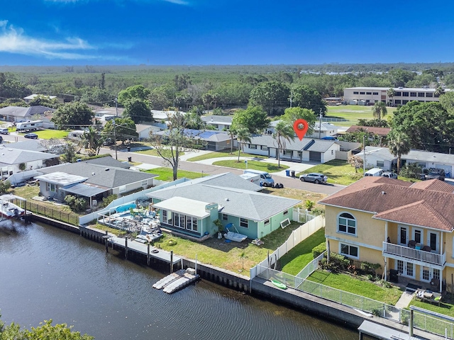 drone / aerial view with a residential view and a water view