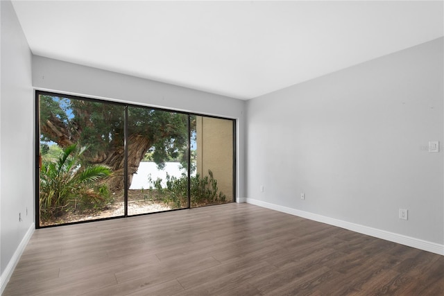 782 Village Lake Ter N Unit 102, Saint Petersburg, FL 33716 - unfurnished room with wood finished floors and baseboards