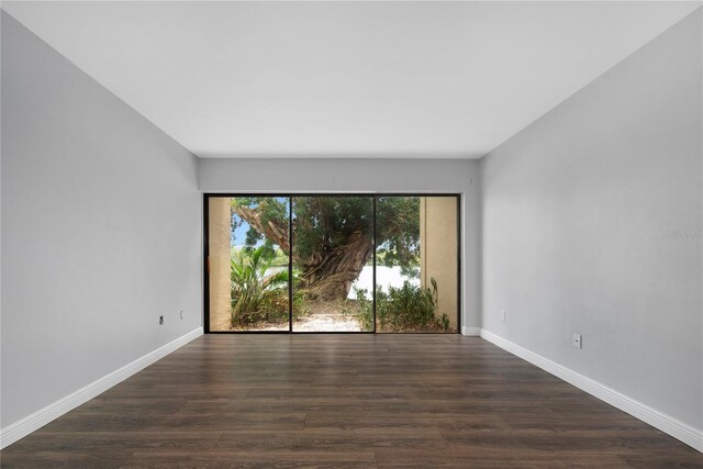 782 Village Lake Ter N Unit 102, Saint Petersburg, FL 33716 - spare room with dark wood-style floors and baseboards