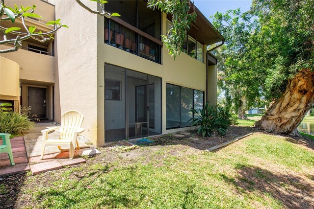 782 Village Lake Ter N Unit 102, Saint Petersburg, FL 33716 - back of house featuring stucco siding and a lawn