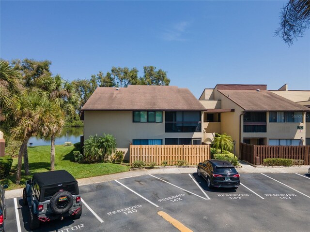782 Village Lake Ter N Unit 102, Saint Petersburg, FL 33716 - view of property featuring uncovered parking and a water view