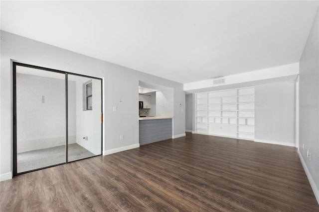 782 Village Lake Ter N Unit 102, Saint Petersburg, FL 33716 - unfurnished bedroom with dark wood-style floors and baseboards