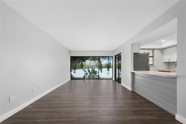 782 Village Lake Ter N Unit 102, Saint Petersburg, FL 33716 - unfurnished living room with dark wood-type flooring, baseboards, and recessed lighting