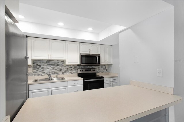 782 Village Lake Ter N Unit 102, Saint Petersburg, FL 33716 - kitchen with stainless steel microwave, electric range oven, a sink, tasteful backsplash, and recessed lighting