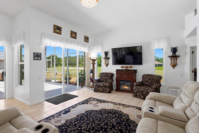 living room with light tile patterned floors, baseboards, and a high ceiling