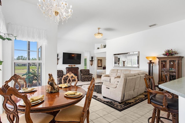 dining area featuring a chandelier, visible vents, and light tile patterned floors