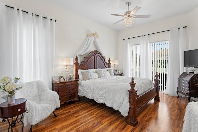 bedroom featuring a ceiling fan, access to outside, and wood finished floors