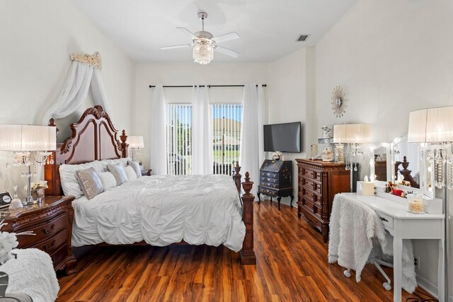 bedroom with access to outside, visible vents, ceiling fan, and wood finished floors
