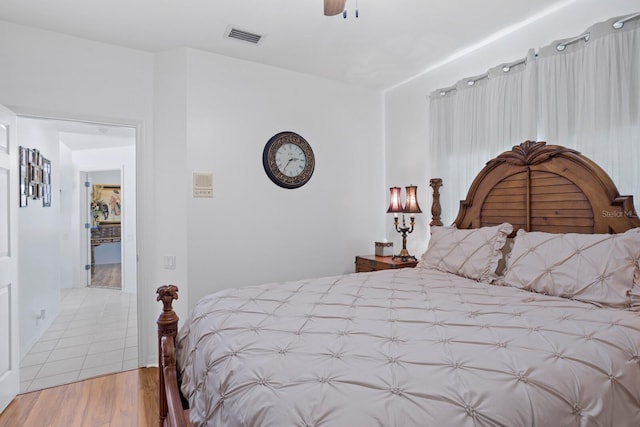 bedroom featuring visible vents, a ceiling fan, and light wood finished floors