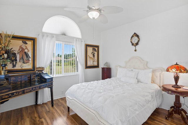 bedroom featuring baseboards, wood finished floors, ceiling fan, and lofted ceiling