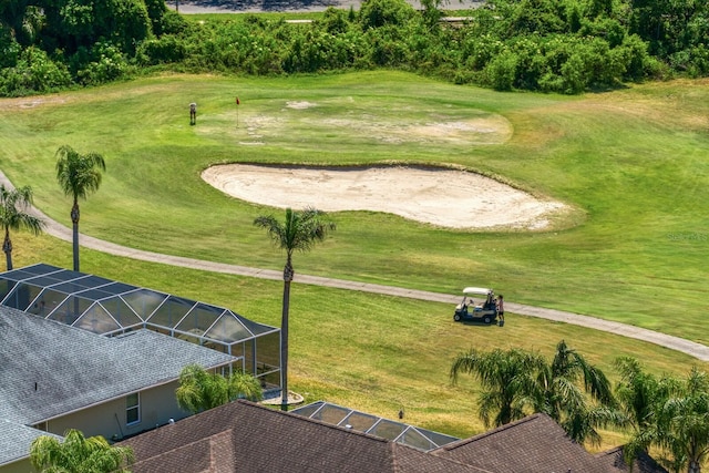 view of home's community featuring a yard and view of golf course