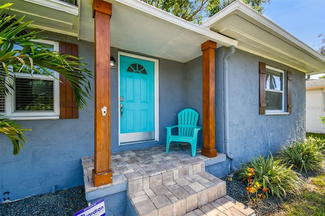 6207 Gulfport Blvd S, Gulfport, FL 33707 - doorway to property with stucco siding and a porch