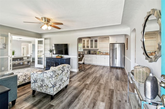 6207 Gulfport Blvd S, Gulfport, FL 33707 - living room with baseboards, arched walkways, ceiling fan, and dark wood-style flooring