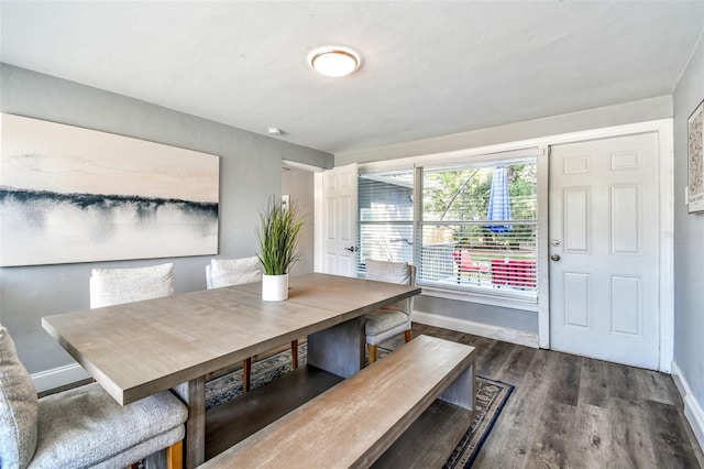 6207 Gulfport Blvd S, Gulfport, FL 33707 - dining space featuring baseboards and dark wood-style floors