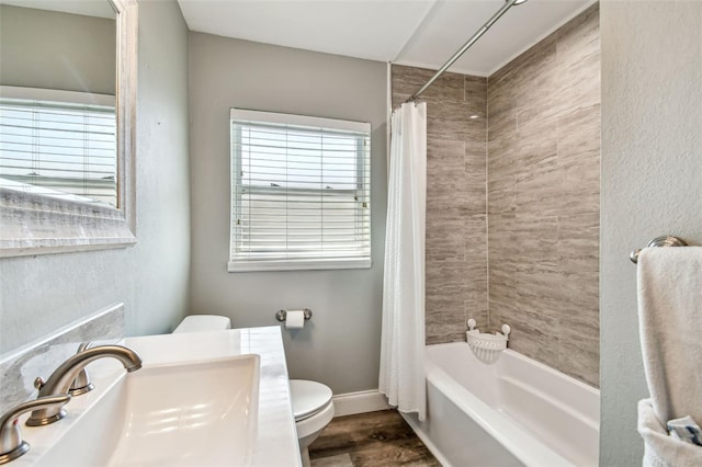 6207 Gulfport Blvd S, Gulfport, FL 33707 - full bathroom with wood finished floors, a sink, baseboards, toilet, and shower / bath combo with shower curtain
