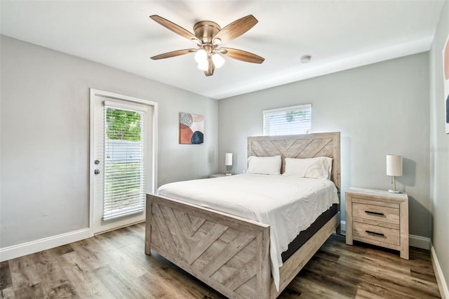 6207 Gulfport Blvd S, Gulfport, FL 33707 - bedroom with baseboards, access to outside, and wood finished floors