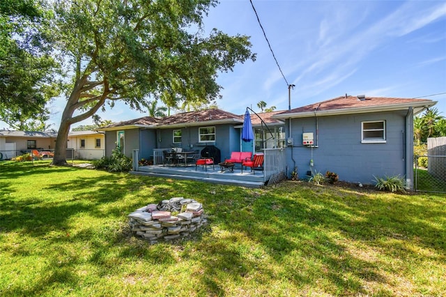 6207 Gulfport Blvd S, Gulfport, FL 33707 - rear view of property featuring fence, a lawn, and a wooden deck