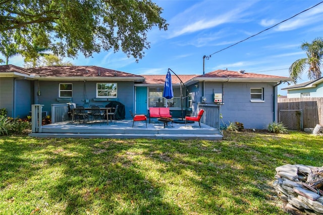 6207 Gulfport Blvd S, Gulfport, FL 33707 - back of house with a yard, fence, concrete block siding, and a deck