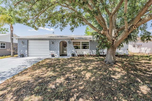 6333 Aberdeen Ave, New Port Richey, FL 34653 - ranch-style house with an attached garage, driveway, and stone siding
