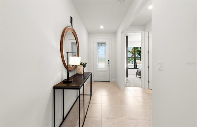 doorway with light tile patterned floors, baseboards, and recessed lighting