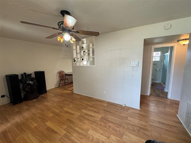 6047 67th Ave N, Pinellas Park, FL 33781 - unfurnished living room with a ceiling fan and wood finished floors