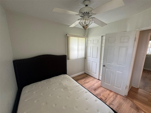 6047 67th Ave N, Pinellas Park, FL 33781 - bedroom featuring baseboards, ceiling fan, a closet, and wood finished floors