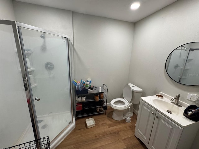 6047 67th Ave N, Pinellas Park, FL 33781 - full bathroom with vanity, toilet, baseboards, a shower stall, and wood finished floors