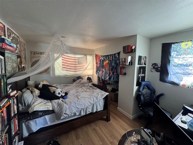 6047 67th Ave N, Pinellas Park, FL 33781 - bedroom featuring a textured ceiling and wood finished floors