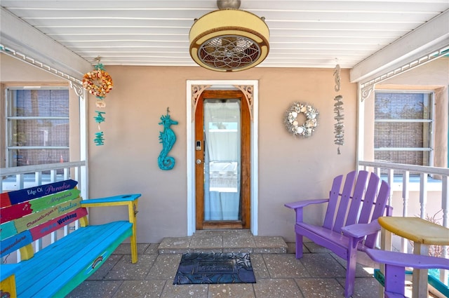 doorway to property with stucco siding
