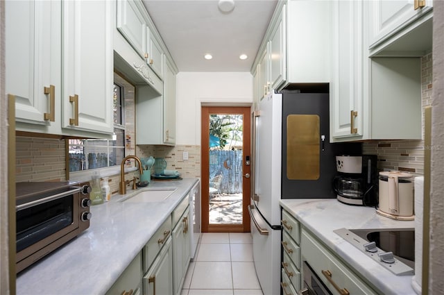 kitchen with a sink, recessed lighting, backsplash, and a toaster
