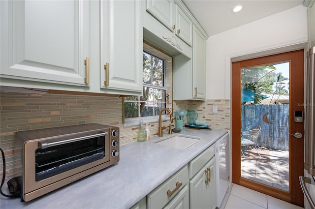 kitchen featuring a sink, light countertops, plenty of natural light, and a toaster