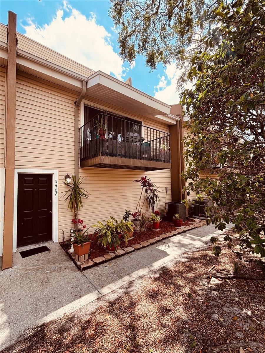 view of side of home featuring a balcony