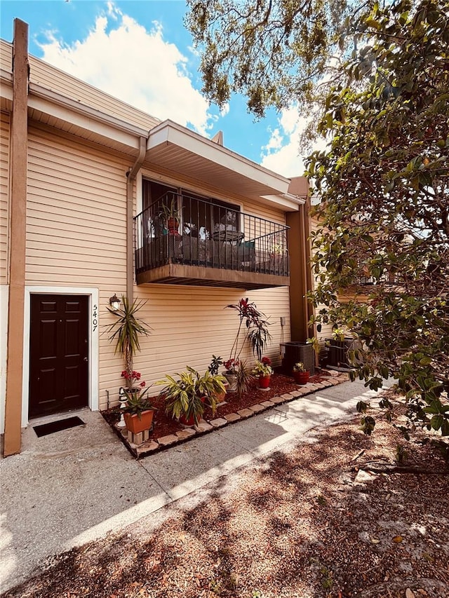 view of side of home featuring a balcony