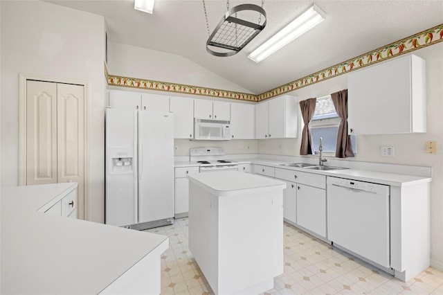 kitchen featuring a kitchen island, white appliances, light floors, a sink, and vaulted ceiling