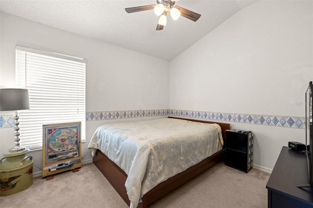 carpeted bedroom with baseboards, ceiling fan, and vaulted ceiling