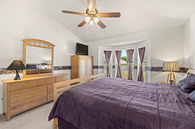 bedroom with access to outside, ceiling fan, vaulted ceiling, and light carpet