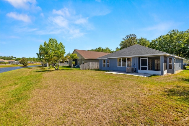 back of property featuring a yard, stucco siding, and central air condition unit