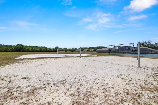 surrounding community featuring volleyball court and fence